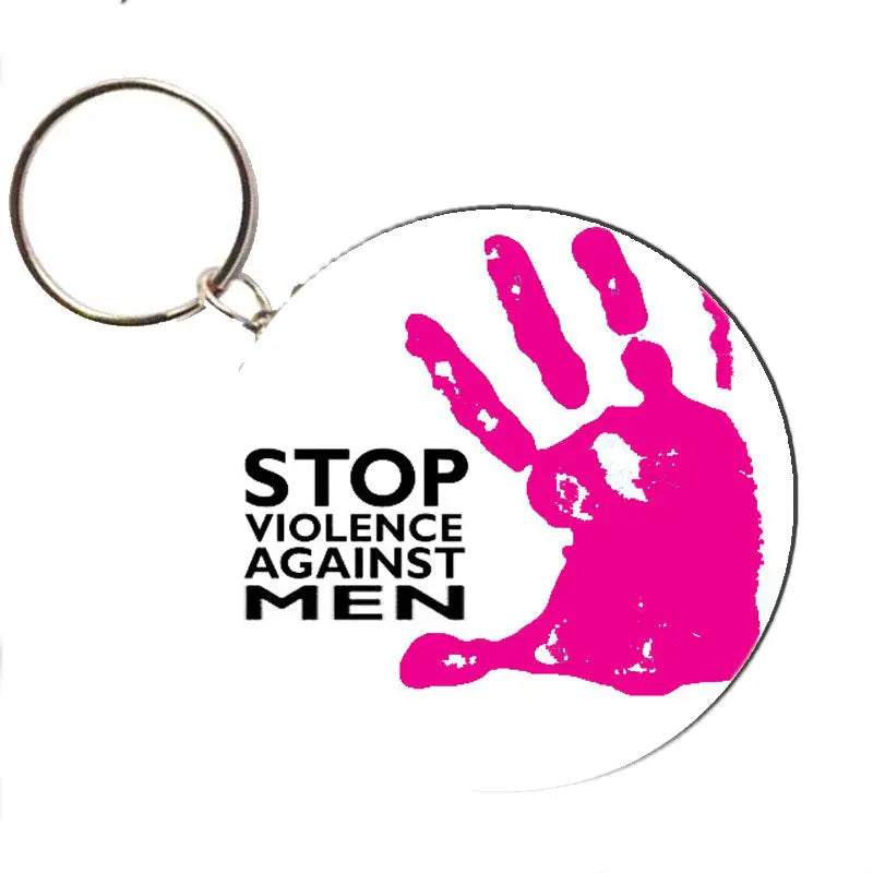 Pink round keychain with raised hand graphic and "STOP VIOLENCE AGAINST MEN" text