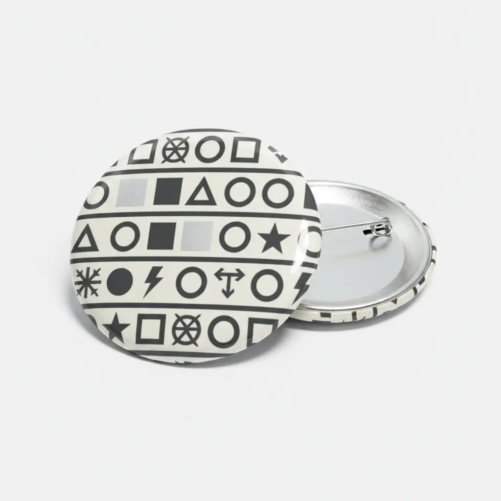 Round black-and-white symbol pinback button with silver metal clasp