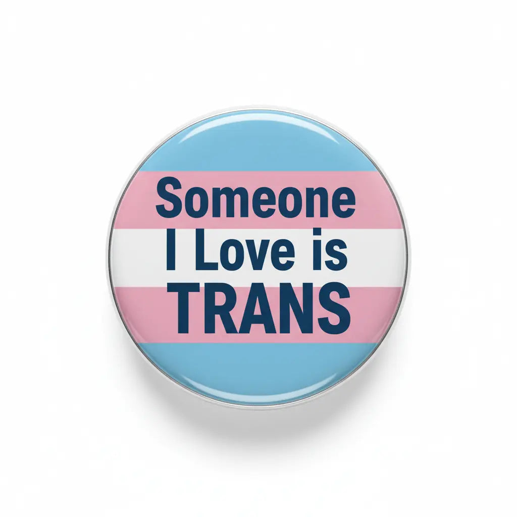 Round transgender pride pin with flag stripes and text "Someone I Love is TRANS"