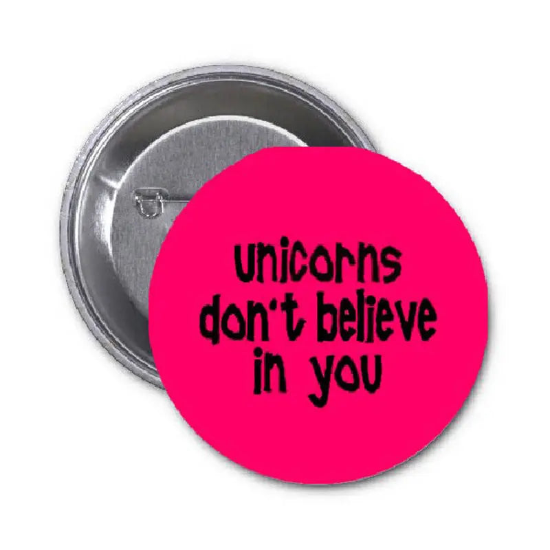 1.25-inch unicorn quote pinback button, magenta with black text 'Unicorns don't believe in you'