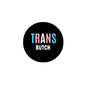 2.25-inch round pinback badge, black with blue TRANS and white BUTCH text