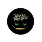 Round black felt badge reel with glowing green Cheshire-cat face design