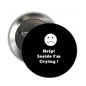 Black pinback badge with white sad face and text “Help! Inside I'm Crying”