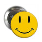 2.25-inch yellow smiley face button pin with black eyes and curved smile