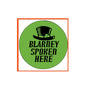 Green St. Patrick's pinback button with black hat icon and “BLARNEY SPOKEN HERE” text