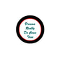 Round black pinback button with white center and teal cursive text, "Dreams Really Do Come True"