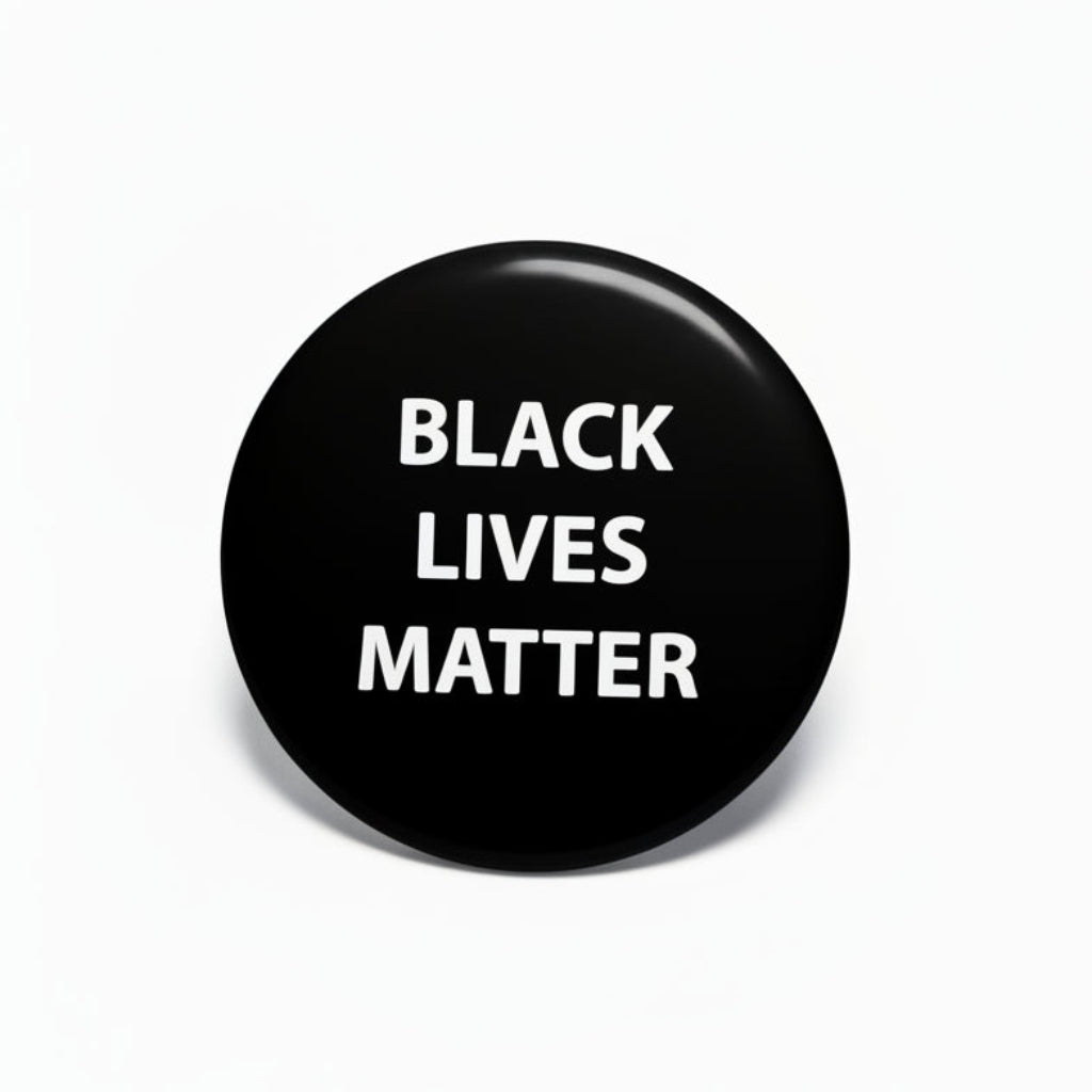 Black Lives Matter pinback, black round button with white 'BLACK LIVES MATTER' text.