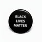 Black Lives Matter pinback, black round button with white 'BLACK LIVES MATTER' text.