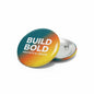 2.25-inch pinback button with teal-to-yellow gradient 'BUILD BOLD' text and silver back pin