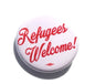 White circular button badge with red 'Refugees Welcome!' text