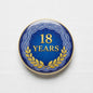 18 Years certificate pinback badge, blue round design with gold trim and laurel wreath