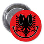 Round red pinback button with black smiley face design and silver clasp