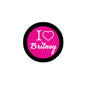 Round pinback badge with black rim, pink center reading 'I ♥ Britney'