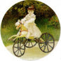 Jean Monet pinback depicting a rider in white on a yellow hobby horse carriage, round