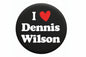 Round black button pin with white “I ♥ Dennis Wilson” text and a red heart