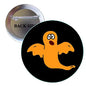 Orange ghost pinback button brooch with black background and metal back, 1.25 inch