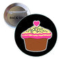 Round black pinback button with pink heart-topped cupcake illustration