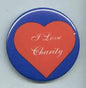 Round charity pin with red heart and 'I Love Charity' lettering on blue background