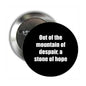 Round black pinback button with white quote text, metal clasp on the back