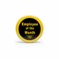 Round gold enamel pin with black center reading “Employee of the Month”