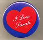 1.25-inch round pinback button with blue edge, red heart, and white text "I Love Sarah"