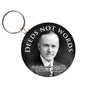 Round keychain with Calvin Coolidge portrait and 'DEEDS NOT WORDS'.