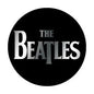 Black round logo button with The Beatles text in silver