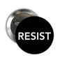 RESIST pinback button, black face with white lettering, 2.25-inch metal back