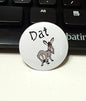 1.25-inch pinback button, white round design with “Dat” and a grey rabbit graphic