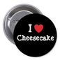 Black I Love Cheesecake pinback button with red heart and white text, metal safety pin back