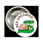 Round pinback button with bee sleeping on green pillow and “BEE DREAMING” text