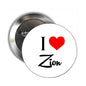 Round metal pinback button with I heart Zion text and red heart