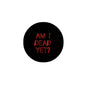 Round black pinback badge with red text "AM I DEAD YET?"