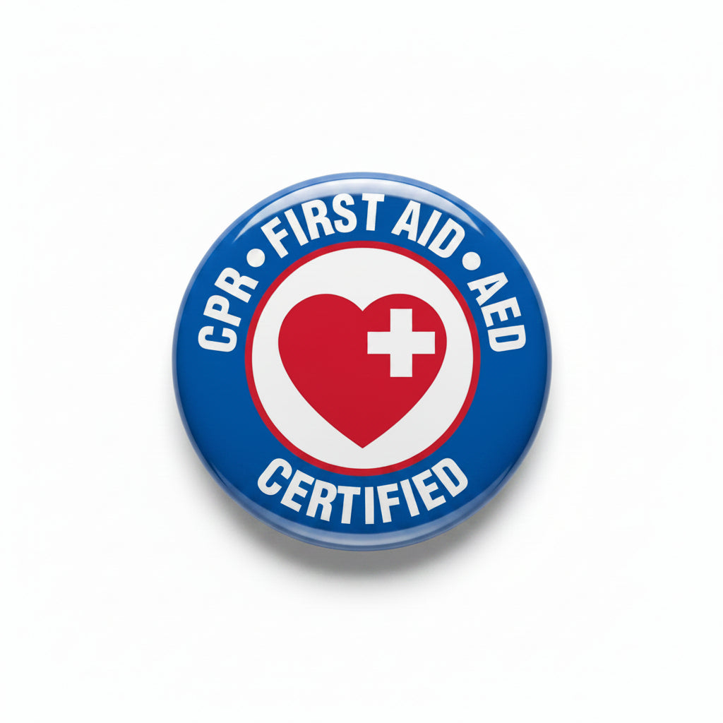 Round CPR First Aid AED pin with red heart and cross, blue border, metal clasp back