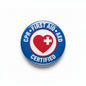 Round CPR First Aid AED pin with red heart and cross, blue border, metal clasp back