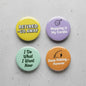 4-pack retirement humor pinback buttons, round assorted colors with humorous sayings