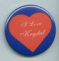 Round I Love Krystal pinback button with orange heart on blue background