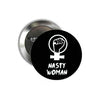 Round pinback button, black with white raised-fist icon and 'NASTY WOMAN' text.