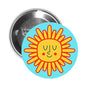 Round pinback button with smiling sun cartoon on light blue background