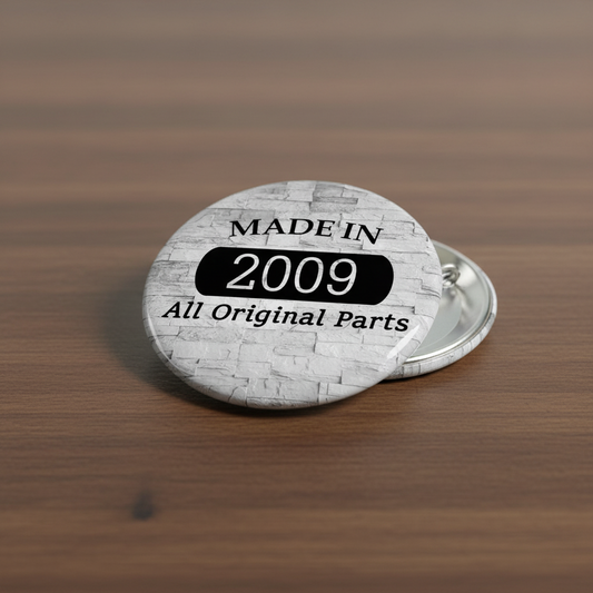 Round gray pinback button with 'MADE IN 2009' and 'All Original Parts' text, pin back