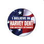 2.25-inch round pinback button, flag design; text 'I BELIEVE IN HARVEY DENT'.