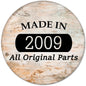 2009 pinback button with “MADE IN 2009” and “All Original Parts” text on wood-look background