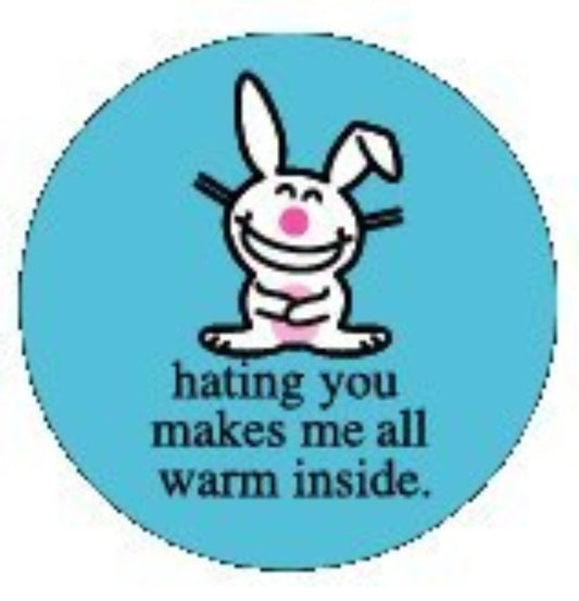 Round blue enamel button with cartoon bunny and text 'hating you makes me all warm inside'