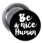 1.25-inch pinback button with white text "Be a nice Human" on black