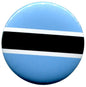 Round Botswana flag enamel pin with blue field, black center stripe, and white bands