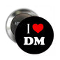 Round black button pinback brooch with red heart and white 'I ♥ DM' text
