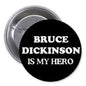 Round black pinback button with white text: 'BRUCE DICKINSON IS MY HERO'