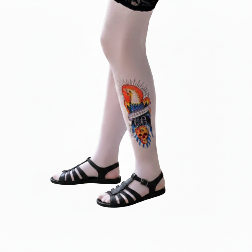 Tattoo leg sleeve with colorful skull and floral art on calf, sheer base