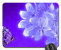 Purple mousepad with large white flowers and a butterfly graphic