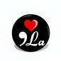 1.25-inch black pinback button with red heart and white “9La” script design